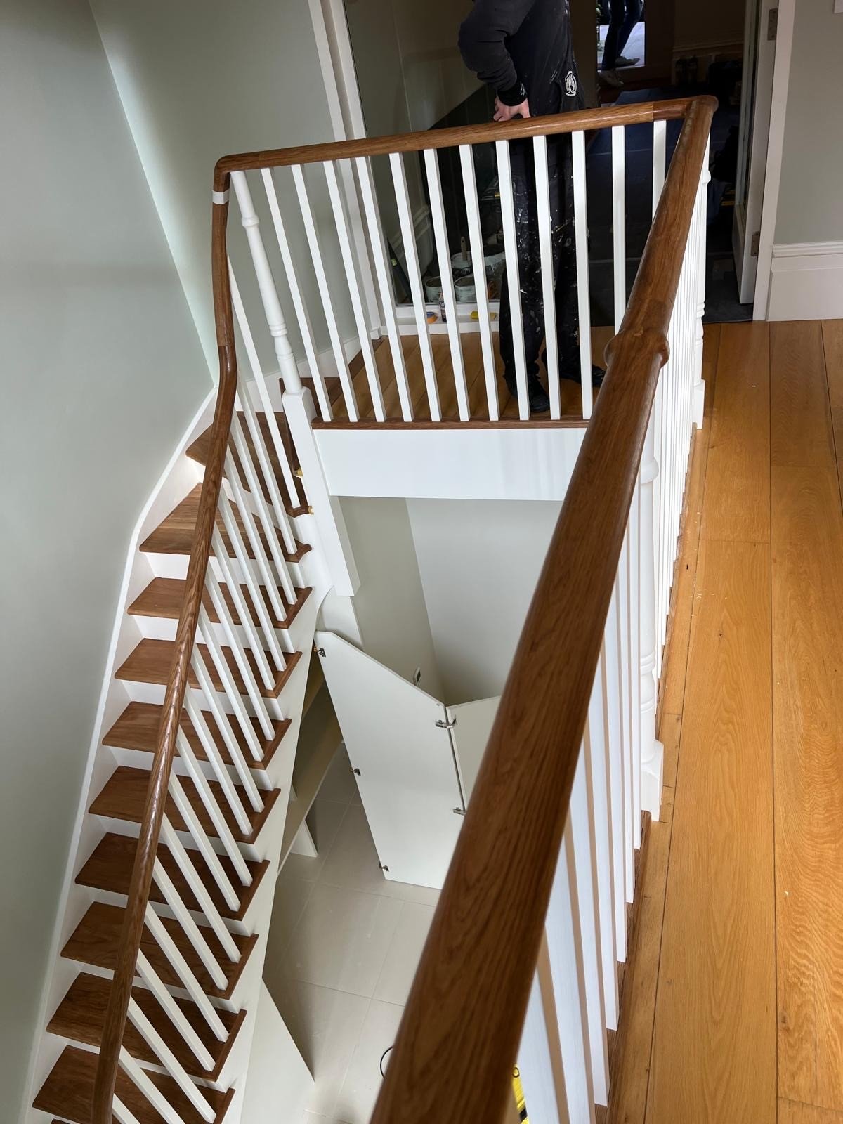 Wooden staircase with white balustrade