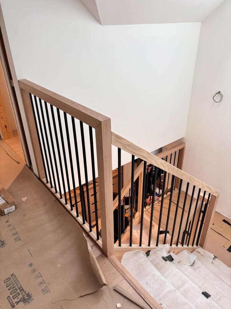 Modern oak staircase with black metal spindles 1