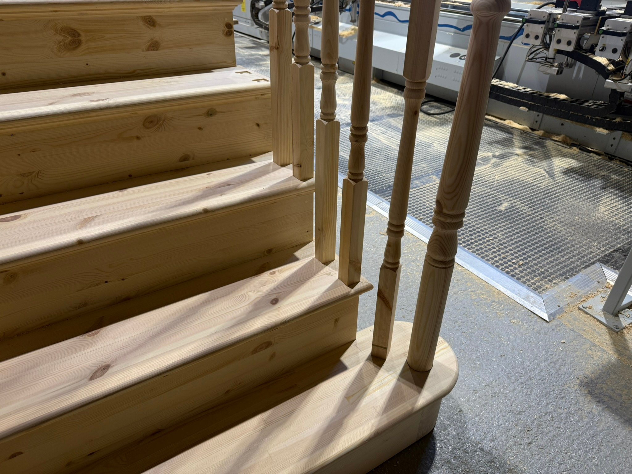 Wooden stairs being crafted in a workshop.