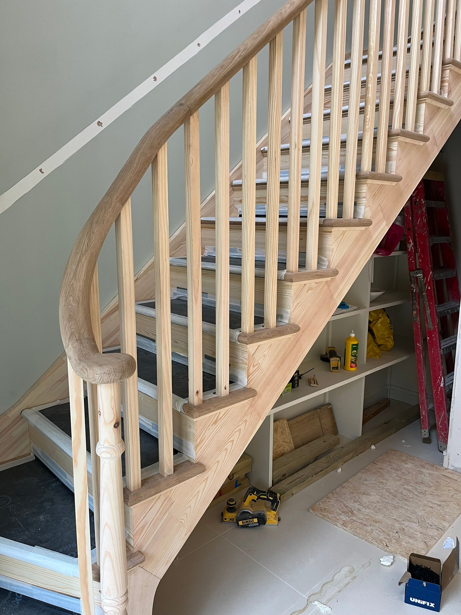 Bespoke curved staircase with oak handrails - London
