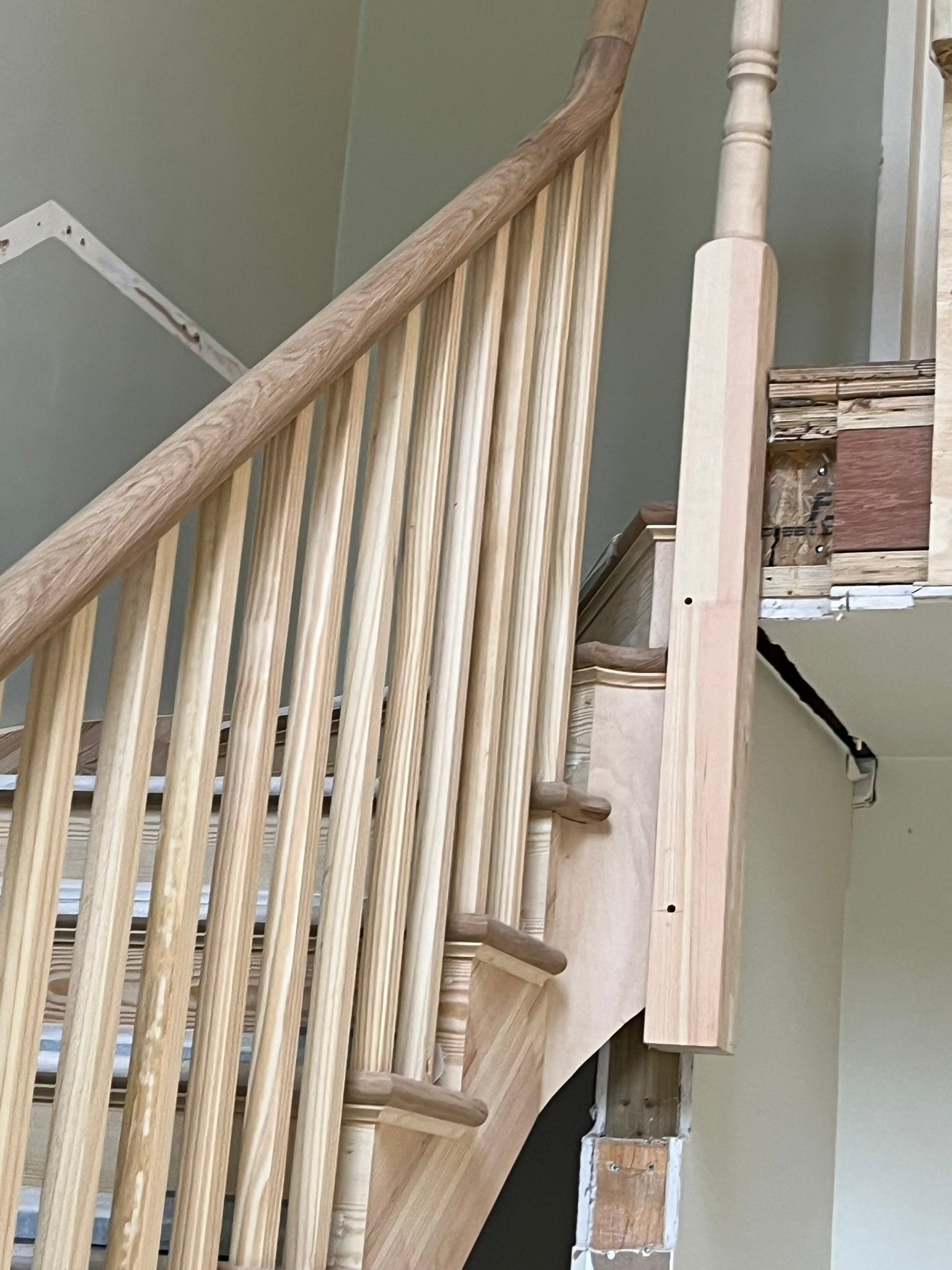 Bespoke curved staircase with oak handrails - London