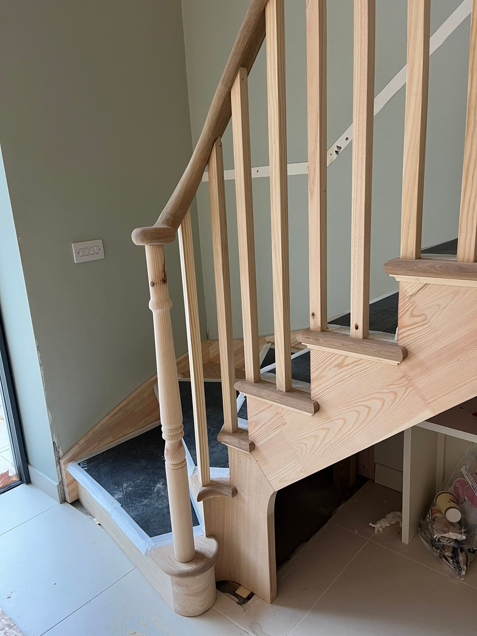 Bespoke curved staircase with oak handrails - London