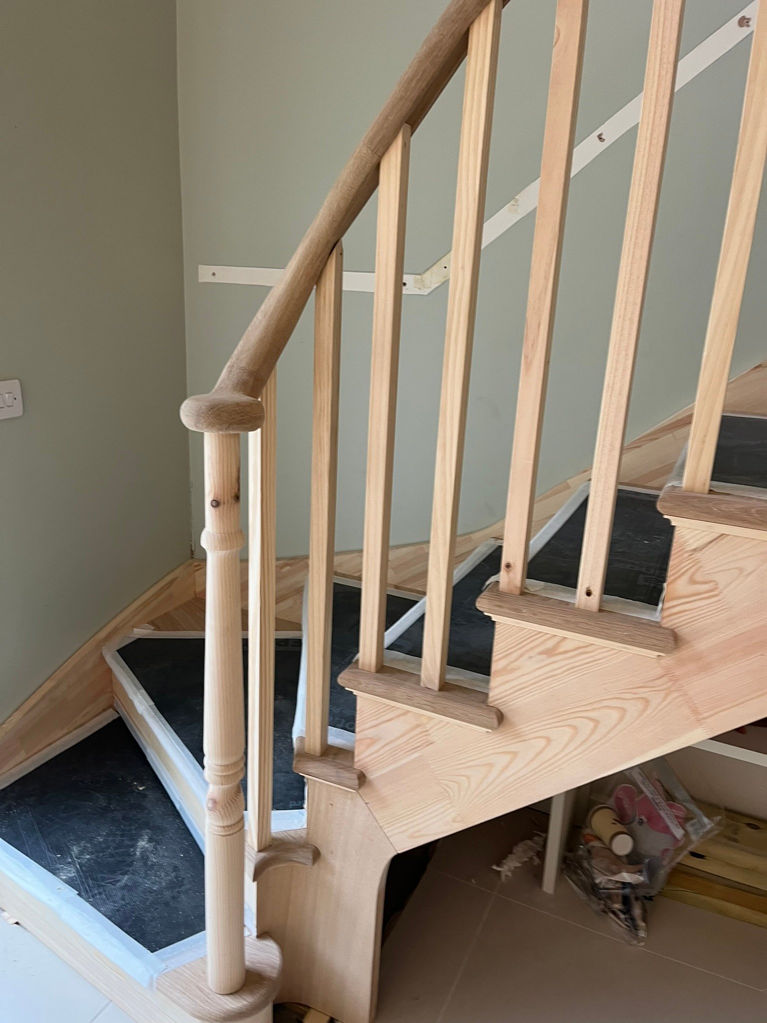 Bespoke curved staircase with oak handrails - London