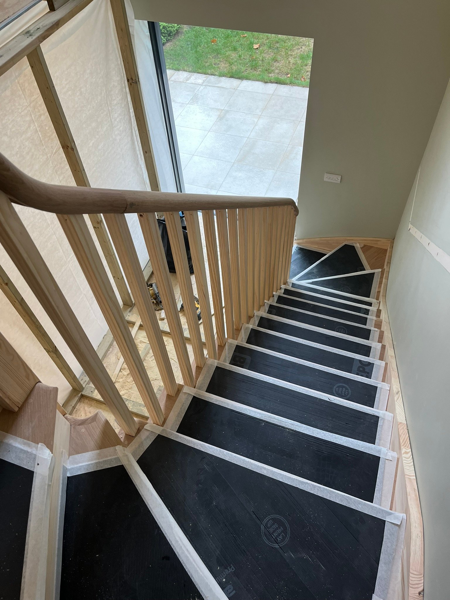 Bespoke curved staircase with oak handrails - London