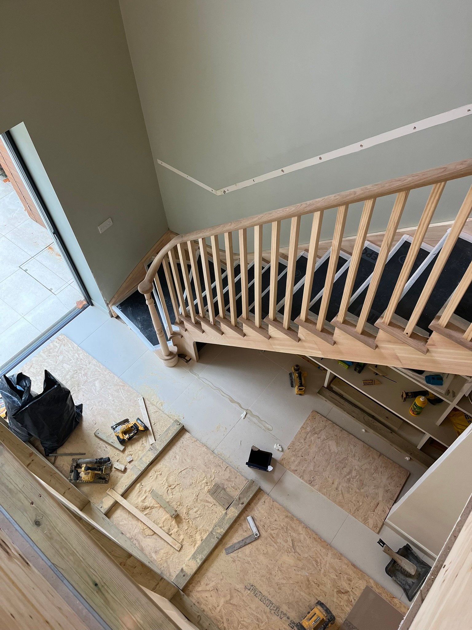 Bespoke curved staircase with oak handrails - London