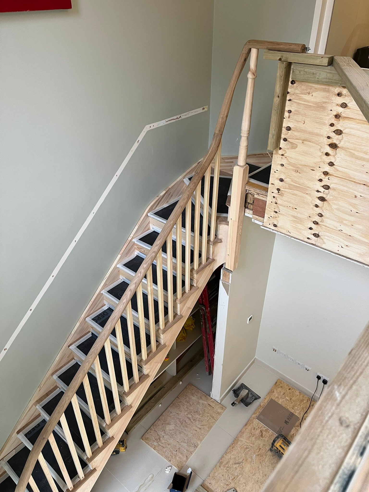 Bespoke curved staircase with oak handrails - London