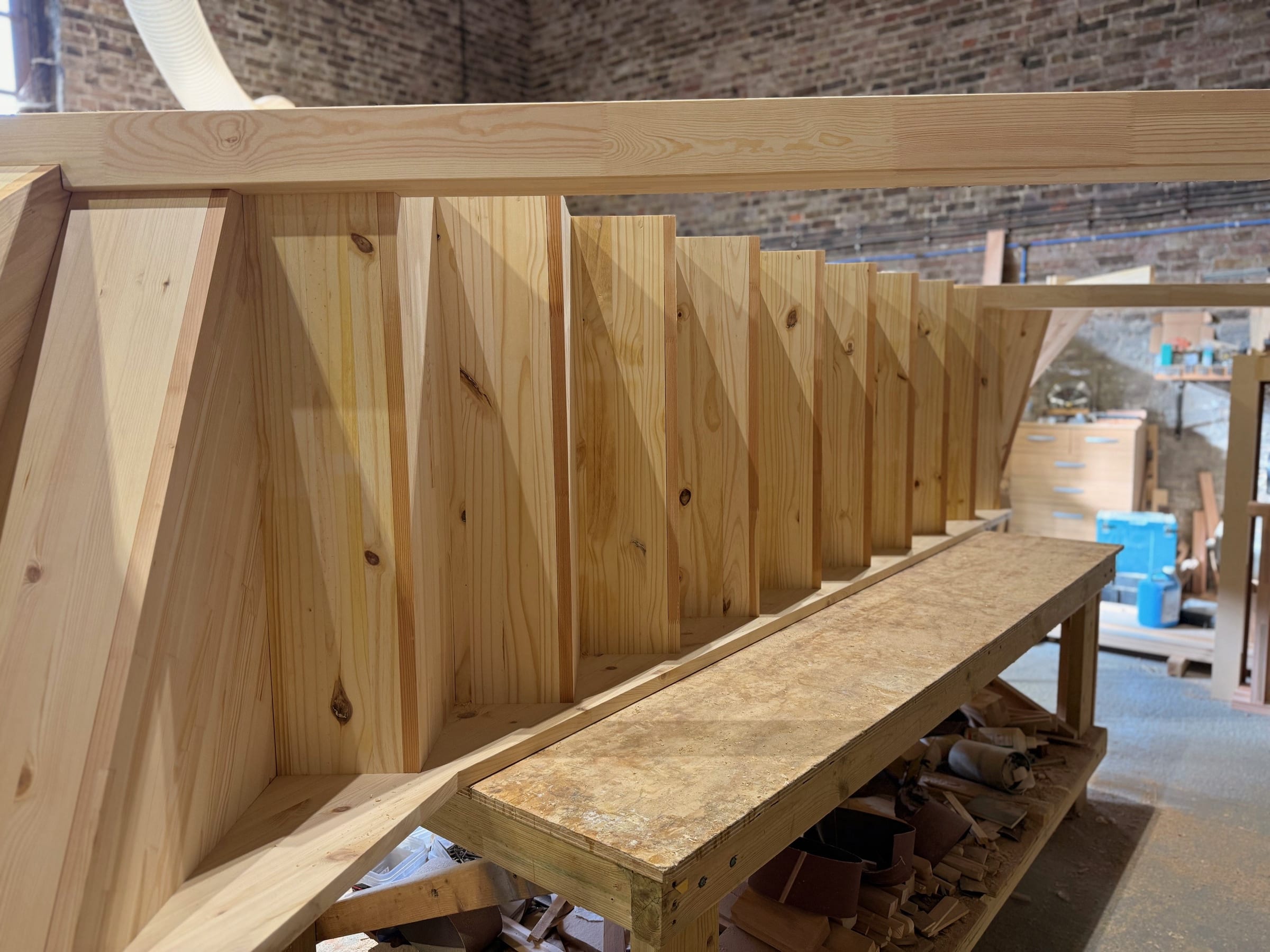 Softwood cut string staircase dry-assembled on the bench in the DAB Stairs workshop